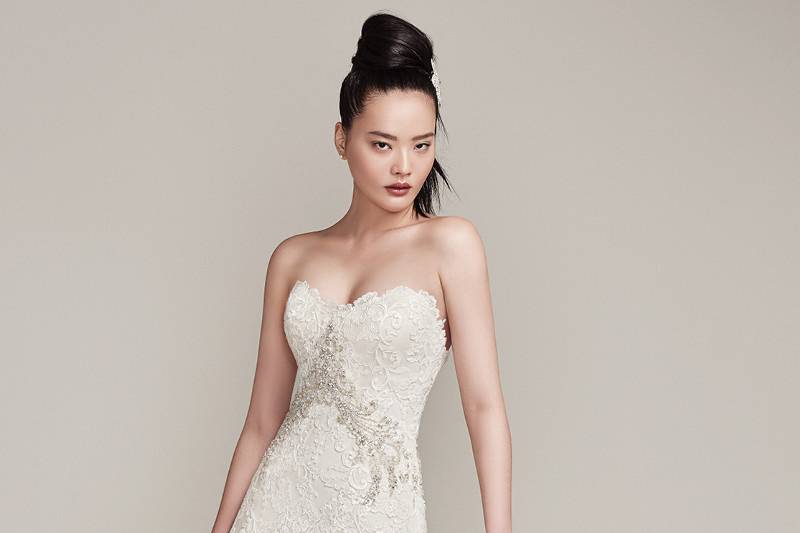 Walker<br> Embroidered lace and tulle add luxurious dimension to this full A-line wedding dress with scalloped scoop neckline and hemline and Swarovski crystal embellishment accenting the natural waist. Finished with crystal buttons over zipper with inner corset closure.