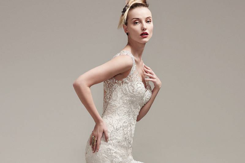 Zanetta<br> Crosshatch tulle adds artistic dimension to this show-stopping fit and flare wedding dress featuring illusion lace scoop neckline and straps. Complete with ruffled flared skirt and luxurious Swarovski crystals. Finished with dramatic illusion back and crystal buttons over zipper closure.