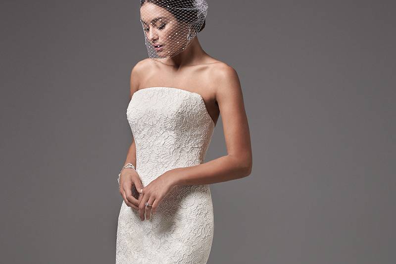 Linley	<br>	This modern and sophisticated strapless fit-and-flare features floral lace motifs and a chic straight neckline. Finished with covered buttons over zipper and inner corset closure.