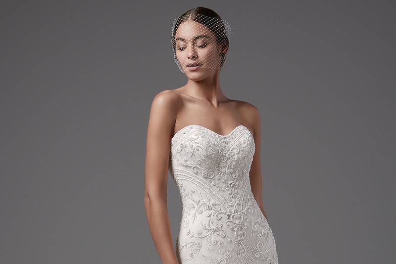 Topaz	<br>	Alluring yet elegant, this strapless, tulle fit-and-flare features shimmering swirls of beaded lace motifs, scoop neckline, and scalloped hem. Complete with crystal buttons over zipper and inner corset closure. Detachable tulle overskirt with beaded waistband sold separately.