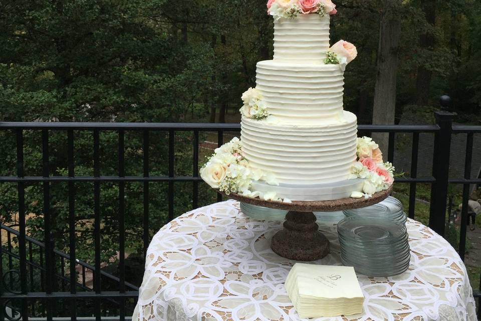 Three tier white wedding cake