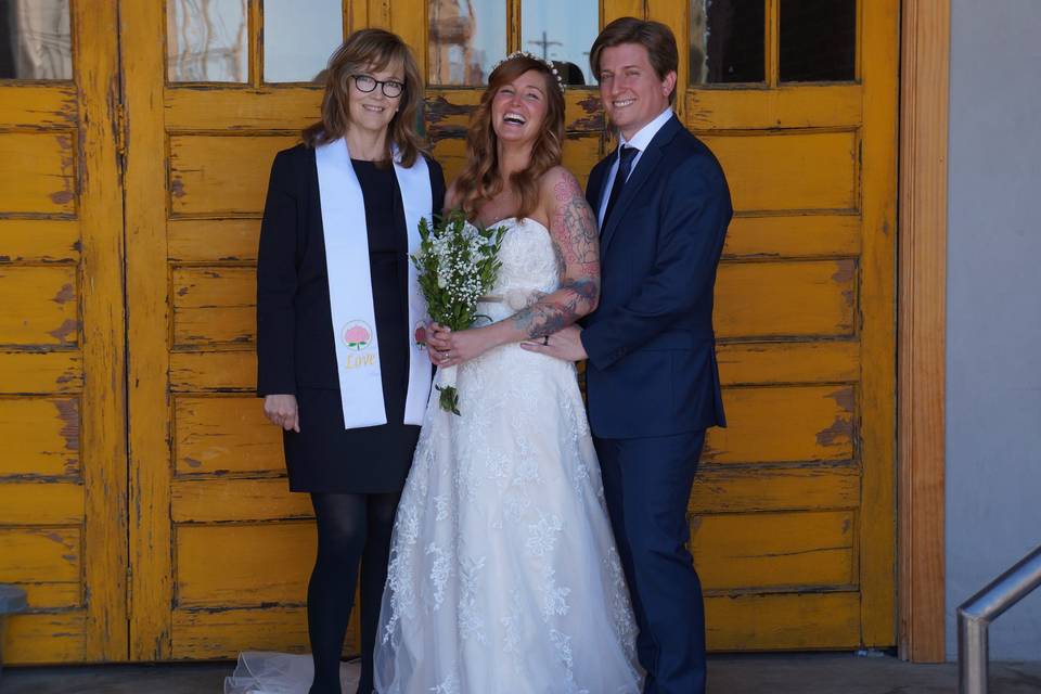 Happy couple with the officiant