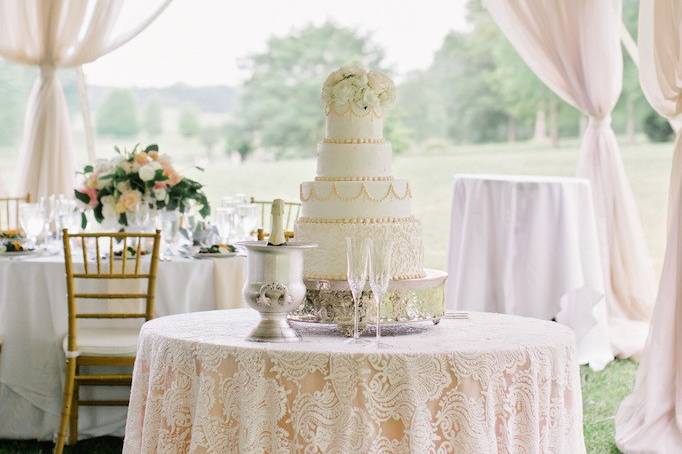 Wedding cake display table with lace linens