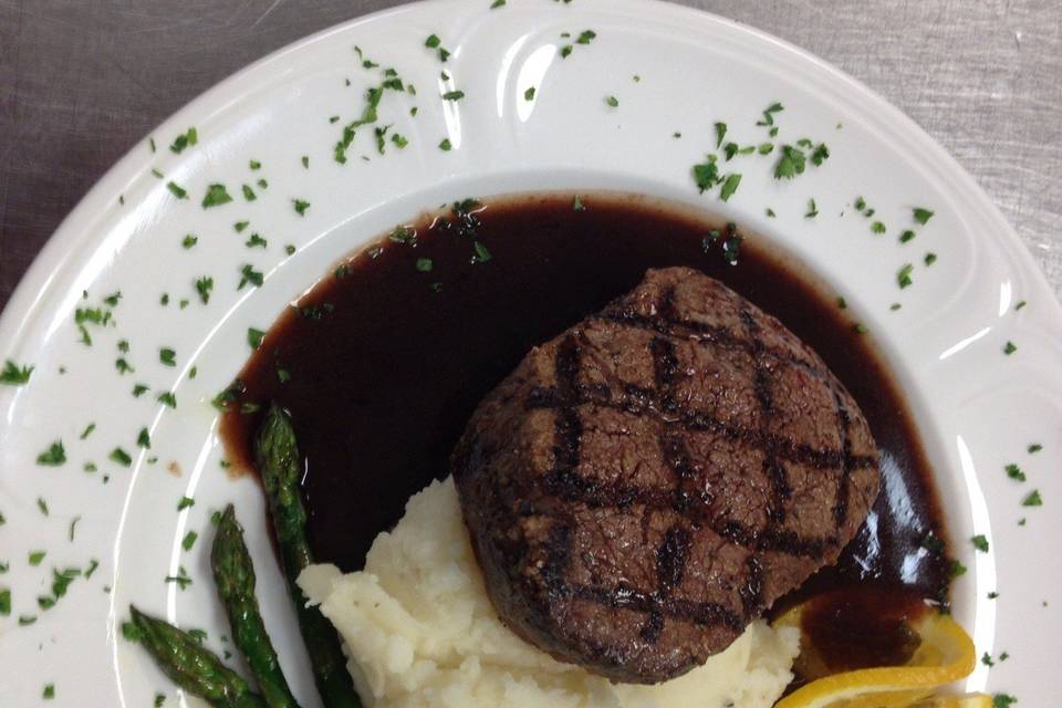 Filet Mignon served with Garlic Mashed Potatoes and Sauteed Fresh Asparagus