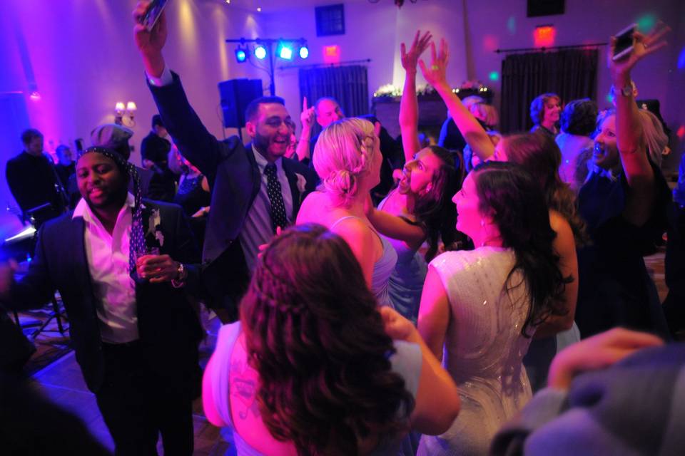 Guests dancing and throwing their hands up