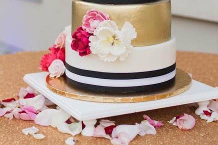 Four tier black, white and gold cake