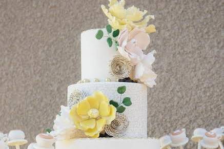 Three tier wedding cake with yellow flowers