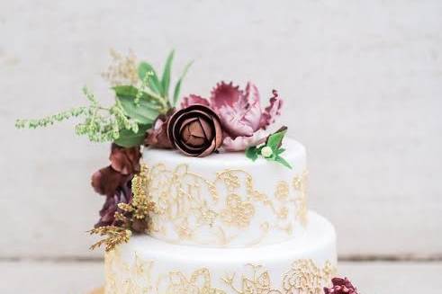 Two tier cake with gold embellishments