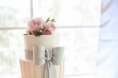 Four tier wedding cake with a grey bow