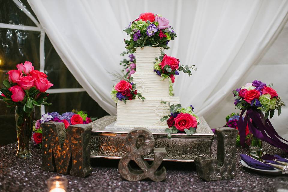 Three tier wedding cake with flowers on top