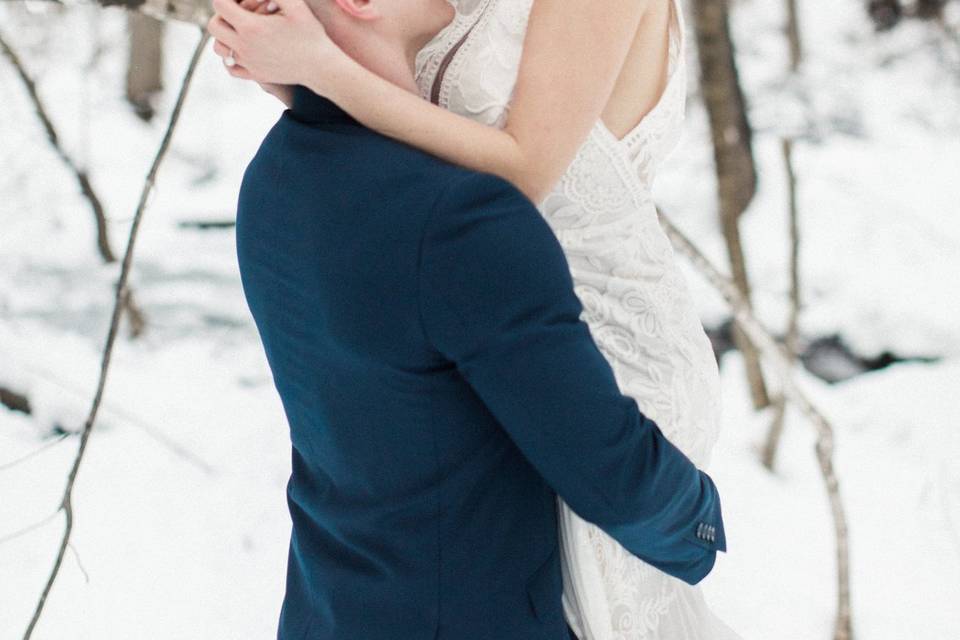 The newlyweds embrace in the snow