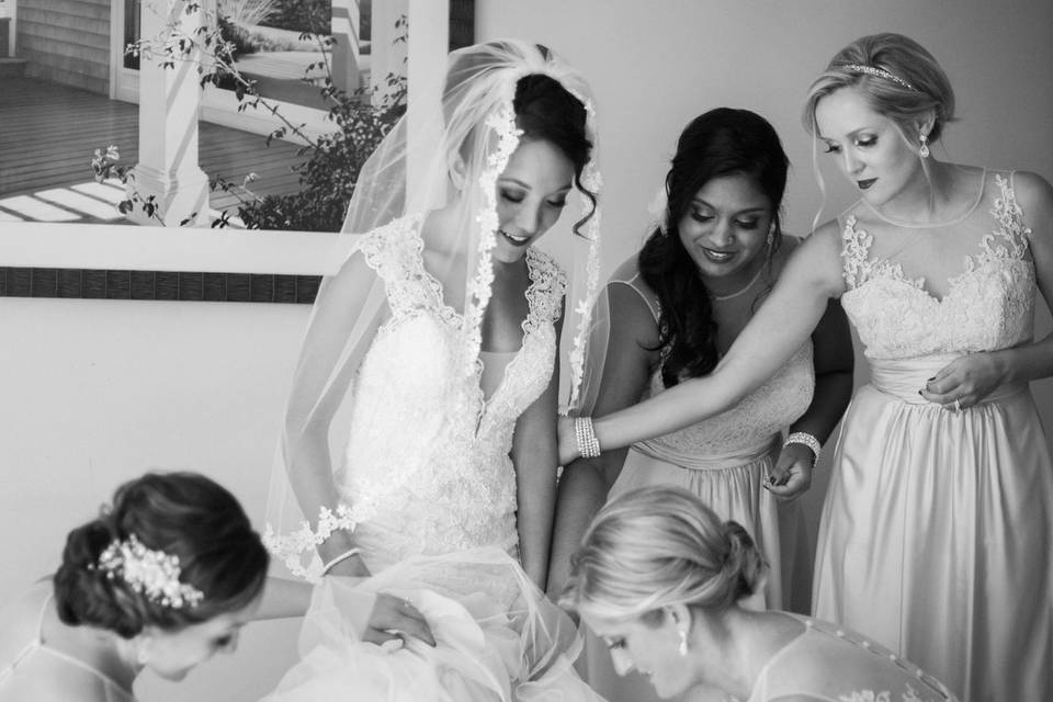 Bride helped by her bridesmaids
