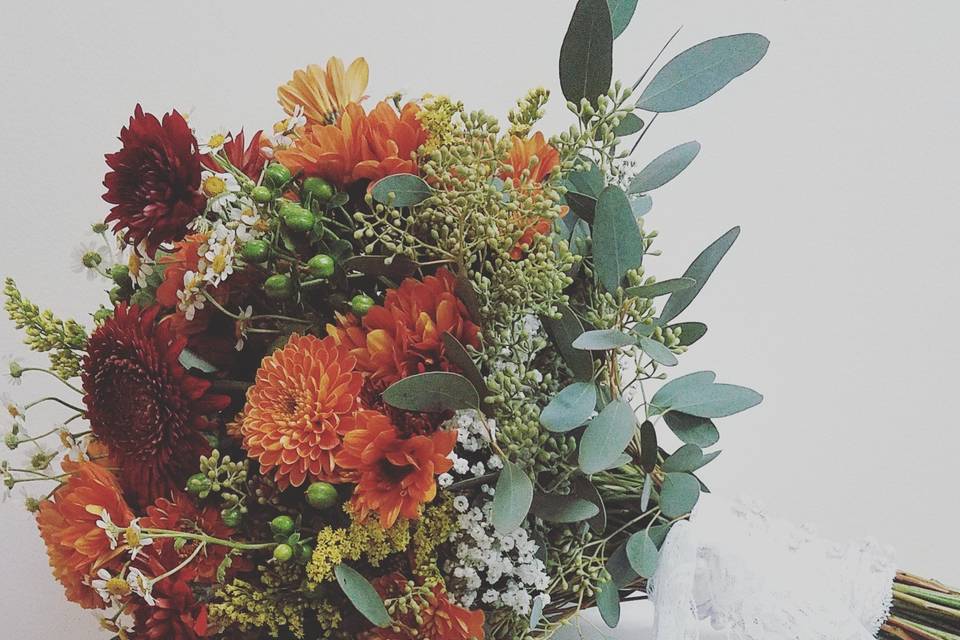 Fall bouquet with mums, baby's breath, hypericum berries and seeded eucalyptus.