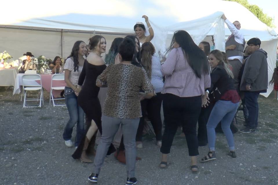 Women dancing around bride