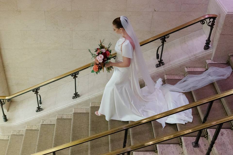 Bride walking down stairs at c