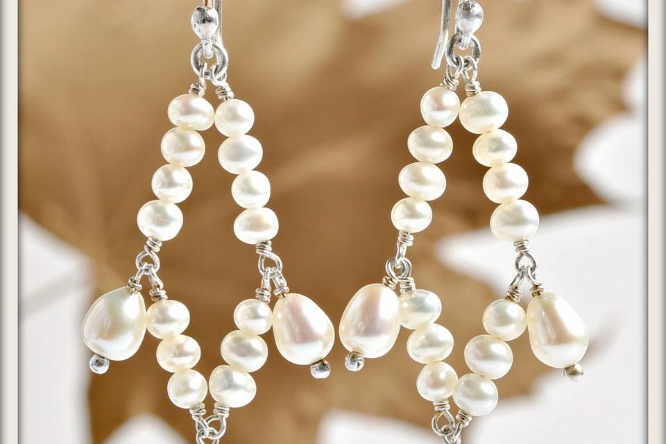 Miyabi Earrings in White Pearl - A stunning diamond design of round white pearls accented by beautiful oval white pearl pendants, suspended from elegant sterling silver French ear wires.