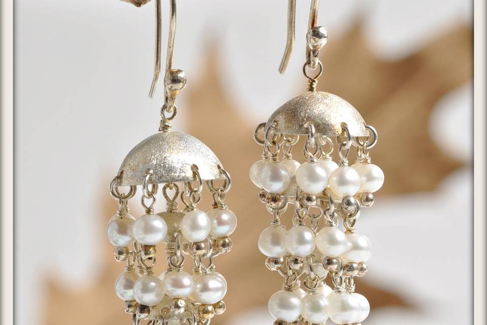 Stardust Earrings in White Pearl - Cascades of delicate white round pearls falling from graduated hand-cut, expertly forged, frosted sterling silver domes, and suspended from sterling silver French ear wires. With every detail exquisitely handcrafted, these earrings are perfectly balanced in style and elegance.