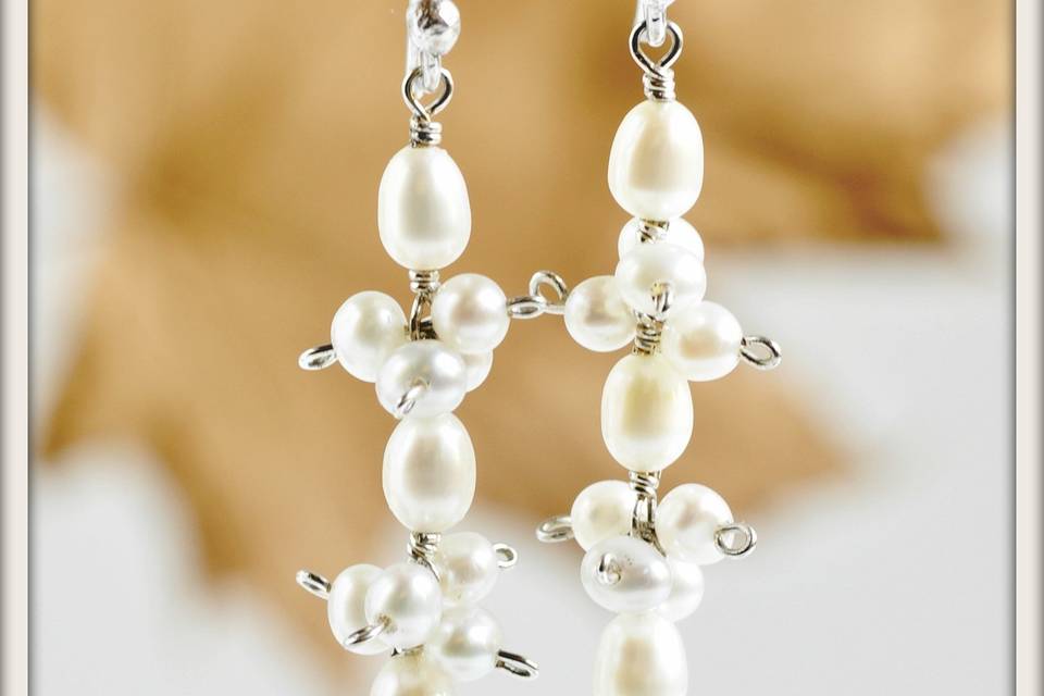 Swing Drop Earrings in White Pearl - Beautiful white rice shaped pearls dangling from sterling silver French ear wires, accented by clusters of lustrous white round pearls.