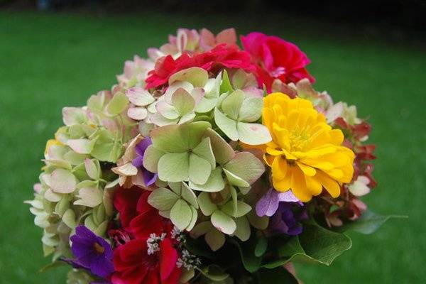 Summer garden bouquet with hydrangeas, herbs, dahlias, and geranium