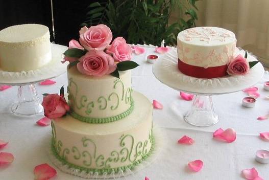 This bride wanted her wedding cakes to also serve as a centerpiece. She chose three designs and we had a cake on each table. The bridal table had a two tier for cutting and pictures and one of each of the other two table cakes