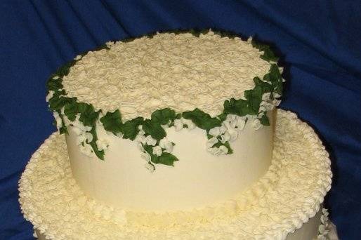 Lilies of the valley provide a stunning contrast to the simple sotas on this wedding cake