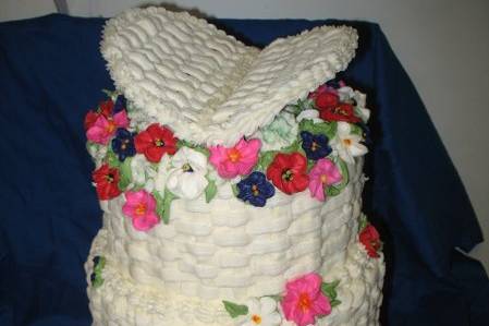 Basket of Flowers is how th e bride described her wedding cake to me. I want iy to look like flowers are spilling out of the top. The flowers piped on the cake matched those used in the ceremony