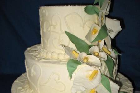 Three tier cake piped with hearts and adorned with hand made calla lilies