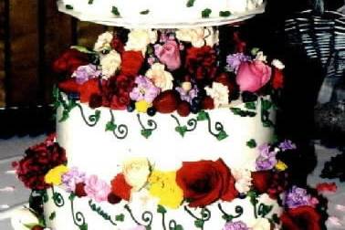 Roses and berries. this cake is topped with a multitude of fresh berries (strawberries,raspberries, blueberries), roses and flowers. I wish I had gotten a better picture because it was very lovely and the picture does not do it justice