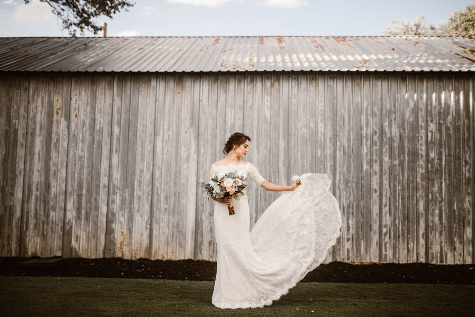 Bride's dress with the barn in the backdrop
