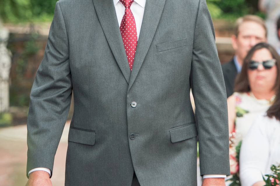 Wedding officiant walking down aisle