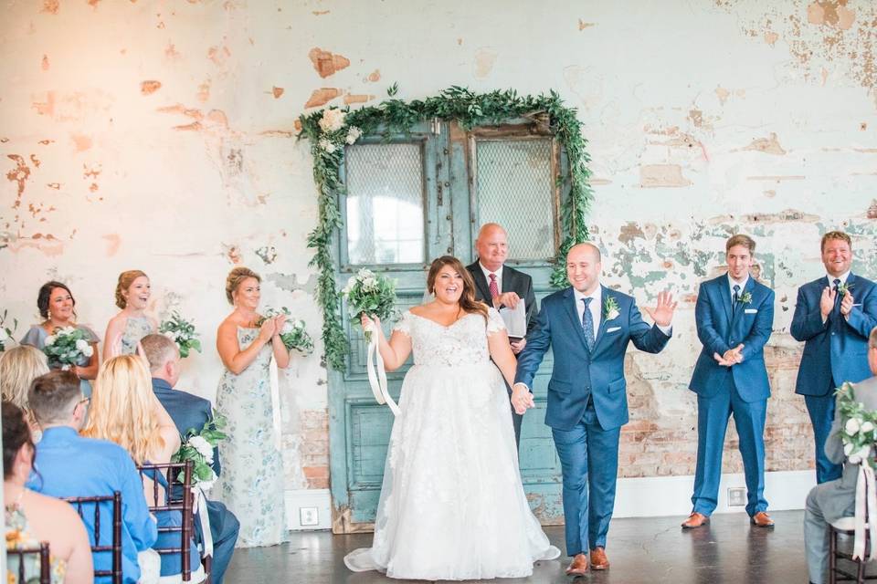 Happy couple walking down aisle