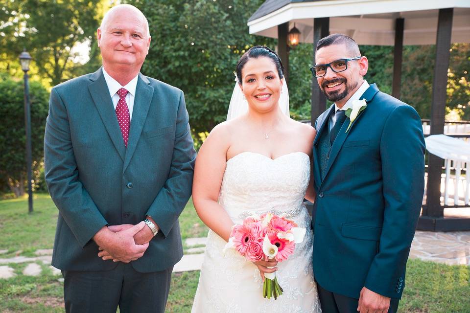 Happy couple with officiant