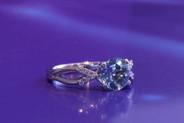 Custom Aquamarine engagement ring with a sprinkle of diamonds on each side.