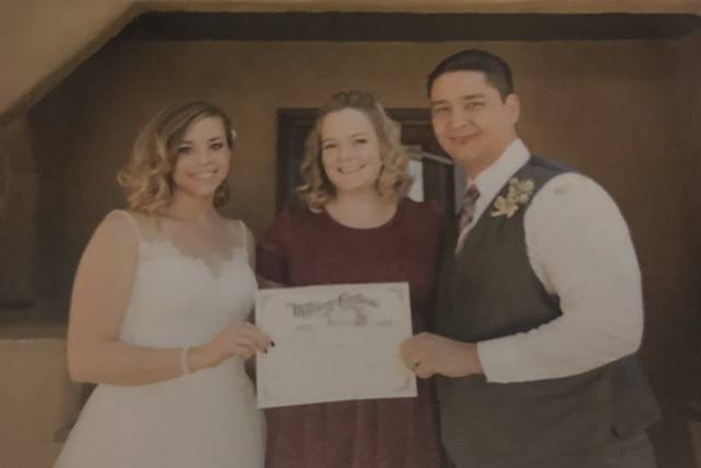 Showing off their marriage certificate