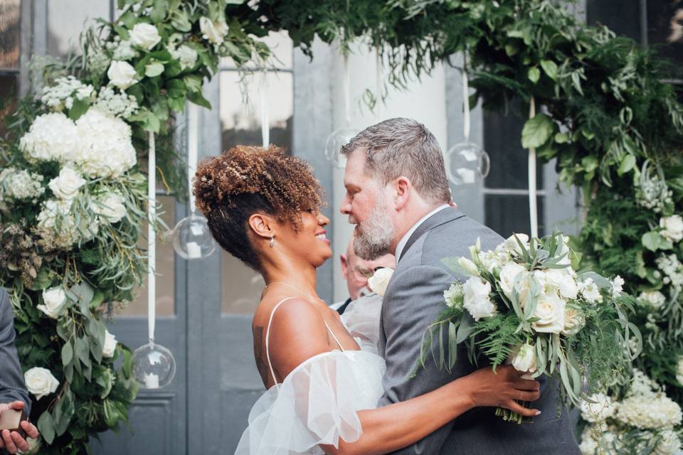 Groom and bride with garland of flowers