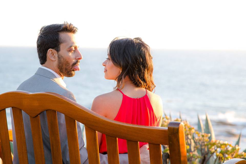 Groom sticks his tongue out with love outside the Montage overlooking the Pacific Ocean