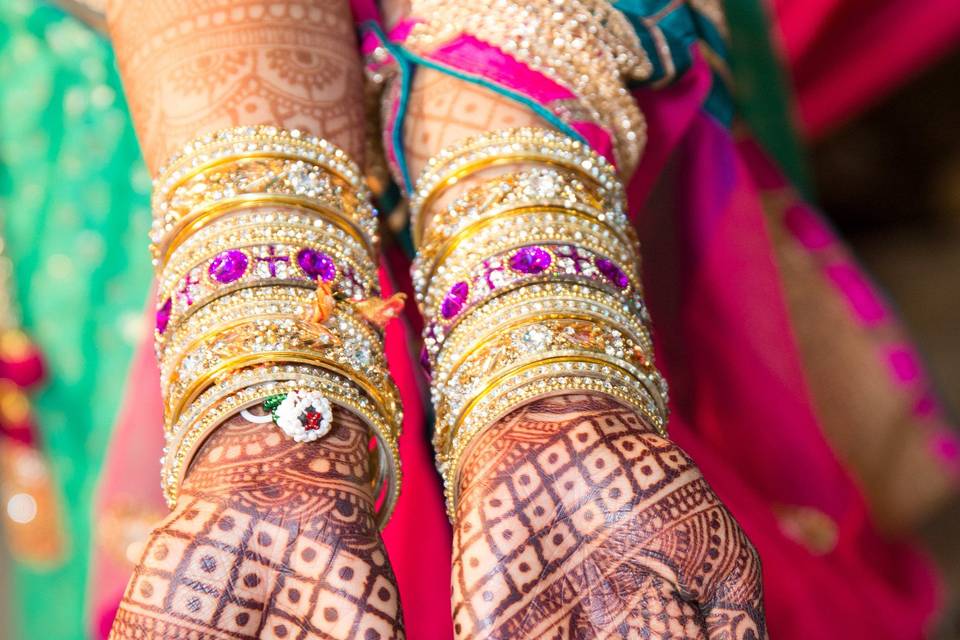 Elaborate mehendi decorates the hands of the bride at the garba and mehendi party