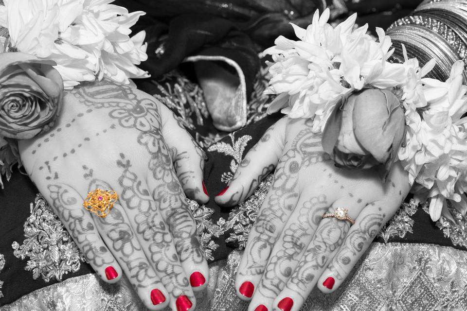 Elaborate mehendi in black and white with a gold and diamond ring in color