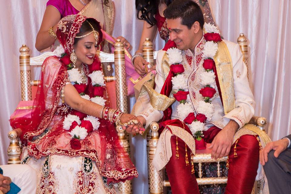 Happily married couple decorated with flowers and garland  at the Wyndham Anaheim Garden Grove