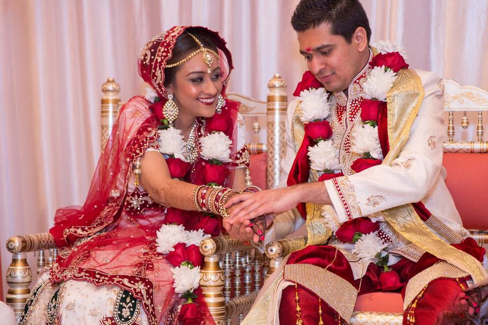 Happily married couple decorated with flowers and garland  at the Wyndham Anaheim Garden Grove