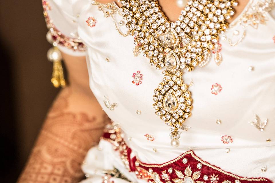 Gold jewelry - necklace, ear rings, head chains - is staple in Indian weddings