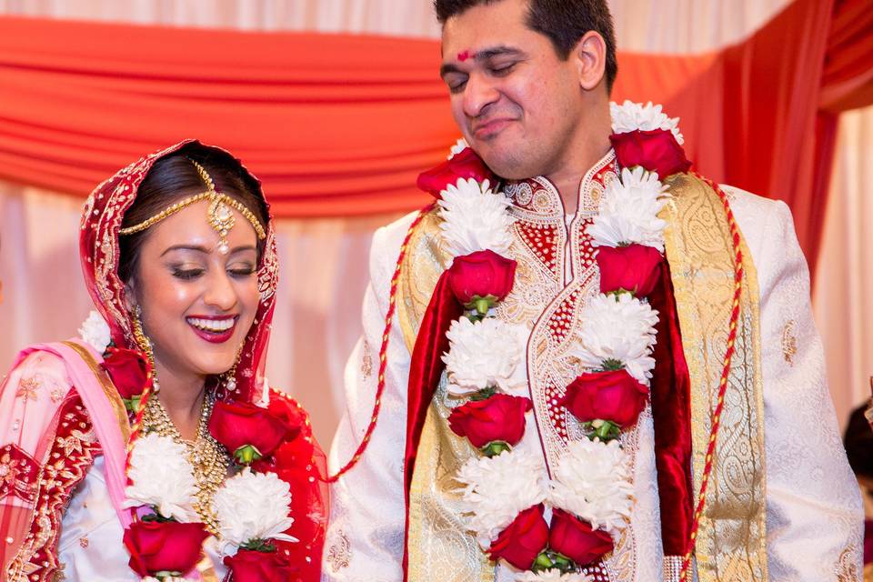 Happily married couple decorated with flowers and garland  at the Wyndham Anaheim Garden Grove