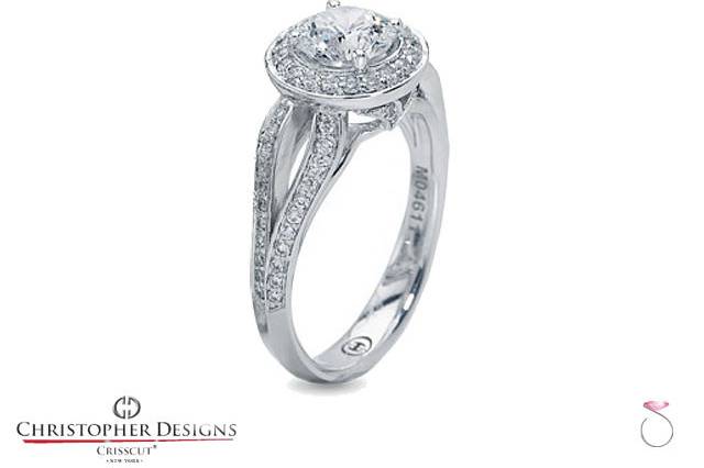 One of the prettiest Diamond Halo engagement rings by Christopher Designs. The Ring features a round shaped Halo set with 20 round diamonds that would surround a 2.00 carat center diamond. The tapered split shank on this ring really complements the design and adds elegance with 20 round diamonds set on each side of the Halo. The ring is crafted in 18K white gold set with 70 diamonds totaling 0.42 carats on the Halo, the sides & the Bridge. Also available for smaller or larger center stones, and your choice of metal, yellow or white 18K gold or Platinum.