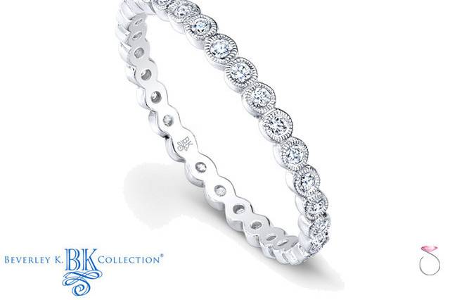 With eternal elegance, this beautiful 18k white gold eternity band features sparkling bezel set 0.26ct diamonds framed with hand milgrain. The band is polished to a pristine finish.