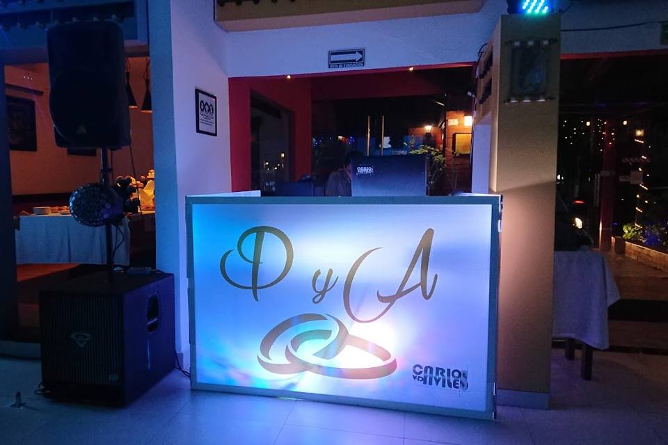 DJ booth illuminated by a custom monogram spotlight