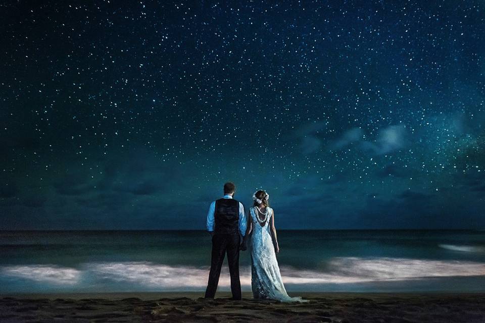 Hawaii wedding couple getting photographed under the stars.