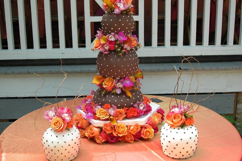 Chocolate fondant covered, carved wedding cake finished with fresh flowers