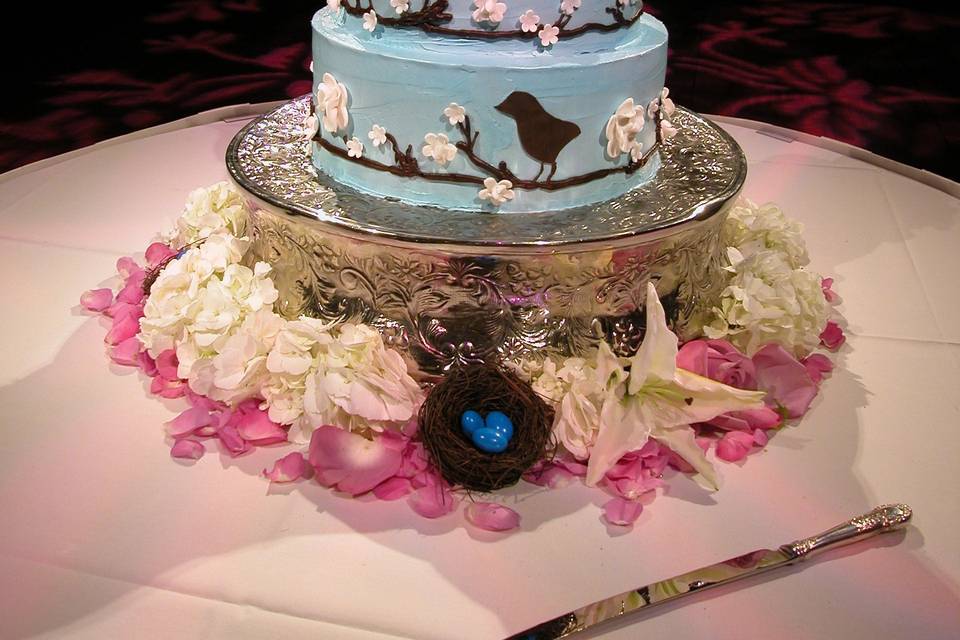 Chocolate Birds and Sugar Flowers adorn this Italian Buttercream wedding cake, then finished with fresh flowers.