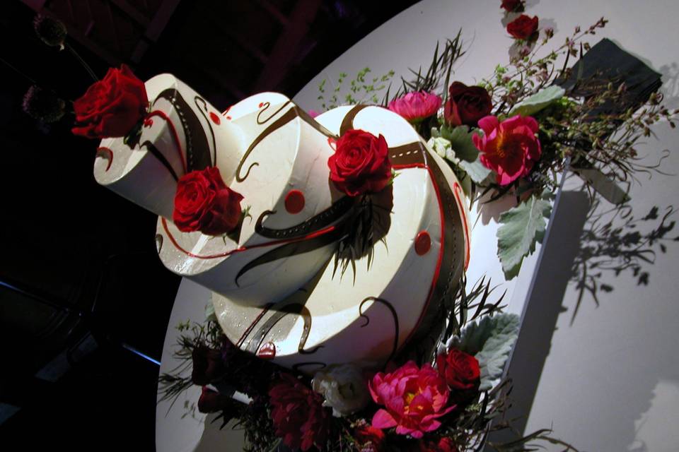Chocolate decorated Italian Buittercream wedding cake finfished with fresh flowers