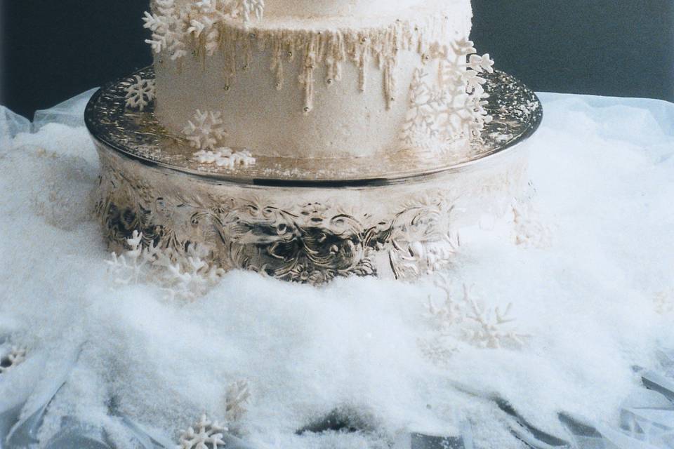 Custom handmade sugar Snowflakes decorate this Frosted Icicle Italian Buttercream wedding cake.